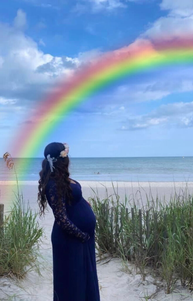 woman on beach with rainbow