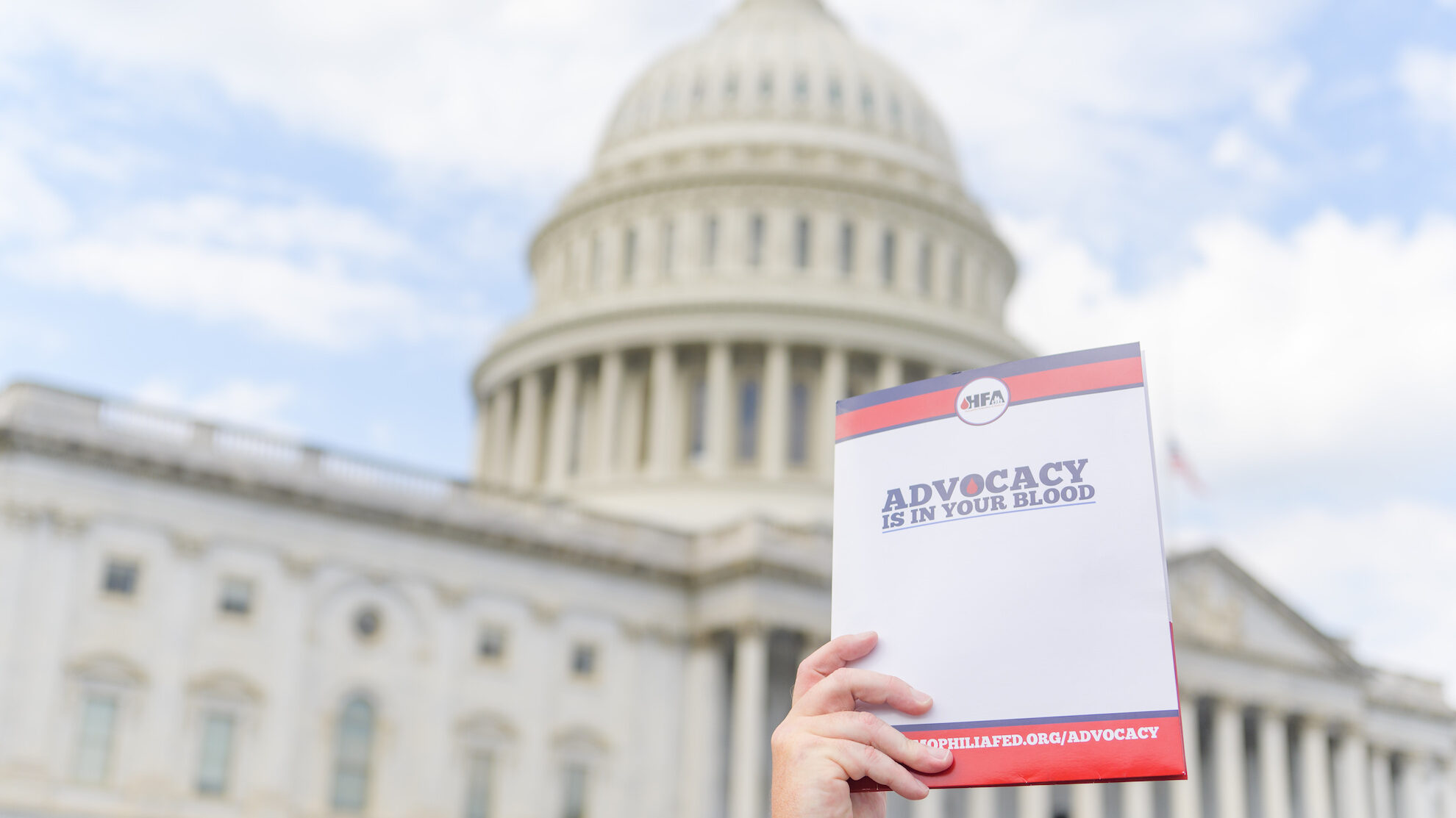 person holding folder in front of Capitol